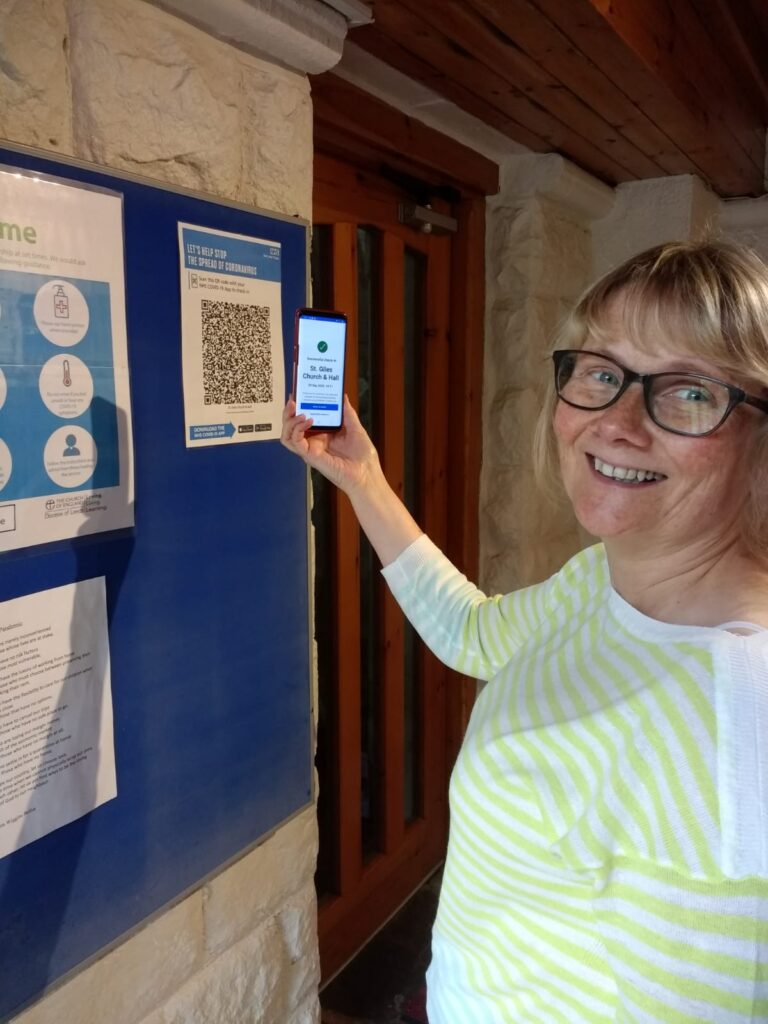 picture of Angela demonstrating the use of the QR code